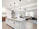 Bright, open-concept kitchen features a large island with pendant lighting and stainless steel appliances at 320 Crider Ct, Woodstock, GA 30188