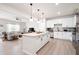 Open-concept kitchen with white cabinets, granite countertops, and stainless steel appliances at 320 Crider Ct, Woodstock, GA 30188