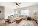 Spacious living room with cozy couch, ceiling fan, and lots of natural light at 320 Crider Ct, Woodstock, GA 30188