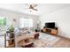 Cozy living room with large TV, ceiling fan, and lots of natural light from the sliding glass door at 320 Crider Ct, Woodstock, GA 30188