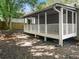 The fenced backyard features a covered porch and brick patio area at 4679 Candlewyck Way, Buford, GA 30518