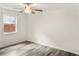 Bedroom featuring ceiling fan, window, and hardwood floors at 4679 Candlewyck Way, Buford, GA 30518