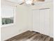 Bedroom featuring closet, window, and hardwood floors at 4679 Candlewyck Way, Buford, GA 30518