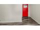 A stylish entryway with a red door, modern flooring, and freshly painted walls, creating a welcoming space at 4679 Candlewyck Way, Buford, GA 30518