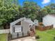 A quaint home with a unique roofline and well-maintained yard, complemented by mature trees and a storage building at 4679 Candlewyck Way, Buford, GA 30518