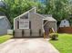Charming home featuring a unique roofline, neutral siding, front window detail and inviting front steps at 4679 Candlewyck Way, Buford, GA 30518