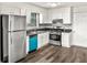 A bright kitchen features white cabinets, stainless steel appliances, and a unique backsplash, seamlessly blending style and functionality at 4679 Candlewyck Way, Buford, GA 30518