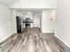 Open living room featuring hardwood floors and stainless steel appliances in the kitchen at 4679 Candlewyck Way, Buford, GA 30518