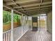 Enjoy outdoor living on the screened-in back porch with wood floors and white railings at 4679 Candlewyck Way, Buford, GA 30518