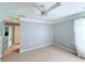 Empty bedroom with neutral paint, a ceiling fan and an attached hallway leading to other rooms at 49 Hampton Dr, Cartersville, GA 30121