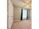 Cozy bedroom featuring neutral walls, a ceiling fan, window with decorative curtains, and closet at 49 Hampton Dr, Cartersville, GA 30121