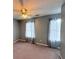 This bedroom boasts neutral paint and carpet, a ceiling fan, and two windows with nice coverings at 49 Hampton Dr, Cartersville, GA 30121