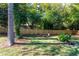 Spacious backyard featuring a lush lawn, privacy fence, mature trees, and an outdoor seating area at 1151 Bromley Rd, Avondale Estates, GA 30002