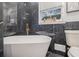 Modern bathroom features a soaking tub, marble tile, and gold fixtures at 1151 Bromley Rd, Avondale Estates, GA 30002