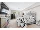 Bright bedroom with mirrored fireplace, large TV, and two windows at 1151 Bromley Rd, Avondale Estates, GA 30002