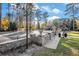 Scenic view of community area with stone wall and lush greenery under a blue sky at 1151 Bromley Rd, Avondale Estates, GA 30002