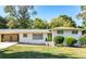 Charming brick home with a well-manicured lawn, covered parking, and vibrant green front door at 1151 Bromley Rd, Avondale Estates, GA 30002