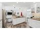 Open kitchen layout with stainless steel fridge, white cabinets, and eat-in area at 1151 Bromley Rd, Avondale Estates, GA 30002