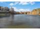 Beautiful view of a serene lake surrounded by trees under a partly cloudy sky at 1151 Bromley Rd, Avondale Estates, GA 30002