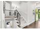 Elegant staircase with wrought iron railing and light-filled landing in a home at 1151 Bromley Rd, Avondale Estates, GA 30002
