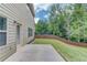 Landscaped backyard featuring green grass, a concrete patio, and a wooden fence for privacy at 2030 Beyers Landing Dr, Buford, GA 30519