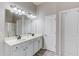Bathroom featuring a double vanity with white cabinets, two sinks, and modern fixtures at 2030 Beyers Landing Dr, Buford, GA 30519