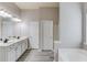 Bathroom featuring a double vanity, tub and shower with modern fixtures and finishes at 2030 Beyers Landing Dr, Buford, GA 30519