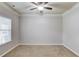 Spacious bedroom with a ceiling fan, neutral walls, and carpeted floors at 2030 Beyers Landing Dr, Buford, GA 30519