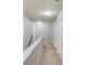 Carpeted hallway with neutral walls and white trim, leading to various rooms at 2030 Beyers Landing Dr, Buford, GA 30519