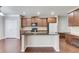 Kitchen island with black countertops and wood cabinets. Hardwood floors throughout at 2030 Beyers Landing Dr, Buford, GA 30519