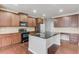 Kitchen island with black countertops and wood cabinets at 2030 Beyers Landing Dr, Buford, GA 30519