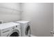 Efficient laundry room featuring modern appliances and white wire shelving for convenient storage at 2030 Beyers Landing Dr, Buford, GA 30519