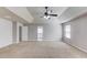Expansive main bedroom featuring plush carpet, a ceiling fan, and ample natural light at 2030 Beyers Landing Dr, Buford, GA 30519