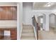 Elegant staircase with carpet runner, wooden banister, and view into the adjacent rooms at 2030 Beyers Landing Dr, Buford, GA 30519