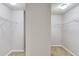 Spacious walk-in closet featuring carpet floors, white walls, and wire shelving for optimal storage solutions at 2030 Beyers Landing Dr, Buford, GA 30519