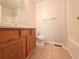Cozy bathroom featuring a vanity with wood cabinets, a toilet, and a shower-tub combo at 294 Spring Leaf Dr, Dallas, GA 30157