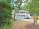 Charming two-story home with a spacious porch and a two-car garage, surrounded by lush greenery at 294 Spring Leaf Dr, Dallas, GA 30157