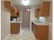 Functional kitchen with wood cabinets, white appliances, and checkered flooring at 294 Spring Leaf Dr, Dallas, GA 30157