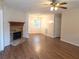 Inviting living room with hardwood floors, a stone fireplace, and a dining area at 294 Spring Leaf Dr, Dallas, GA 30157