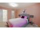 Comfortable bedroom featuring neutral carpet, pink walls, a gray headboard and a walk-in closet at 440 Barrington W Dr, Roswell, GA 30076
