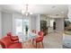 Bright dining room with modern light fixture and stainless steel appliances at 440 Barrington W Dr, Roswell, GA 30076