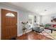Charming entryway with wood door, gray paint, and hardwood floors leading to a cozy living space at 440 Barrington W Dr, Roswell, GA 30076