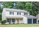 Charming two-story home featuring a well-maintained lawn, dark blue shutters and a two-car attached garage at 440 Barrington W Dr, Roswell, GA 30076