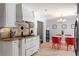 Beautiful kitchen featuring white cabinets, granite countertops, stainless steel appliances, and eat-in dining area at 440 Barrington W Dr, Roswell, GA 30076