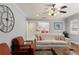 Comfortable living room with hardwood floors, neutral paint, ceiling fan, and view into eat-in kitchen at 440 Barrington W Dr, Roswell, GA 30076