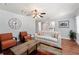 Cozy living room with hardwood floors, large windows and a decorative ceiling fan at 440 Barrington W Dr, Roswell, GA 30076