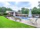 Beautiful backyard with a sparkling pool, lush lawn, and ample seating areas for entertaining at 879 Old Tucker Rd, Stone Mountain, GA 30087
