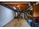 Unfinished basement with concrete floor, white-washed block walls, and open ceiling with exposed ductwork at 879 Old Tucker Rd, Stone Mountain, GA 30087