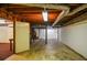 Unfinished basement with concrete floor, utility pipes, and painted cinderblock walls at 879 Old Tucker Rd, Stone Mountain, GA 30087