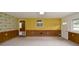 Spacious unfinished basement with unique wallpaper, paneled walls, and a separate entrance to the outside at 879 Old Tucker Rd, Stone Mountain, GA 30087